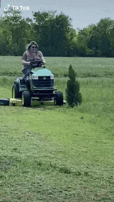 Man Riding Lawn Mower In Field GIF