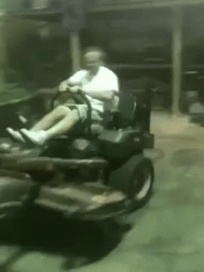 Man Riding Lawn Mower in Garage