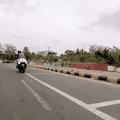 Man Riding Motorcycle Down Road GIF