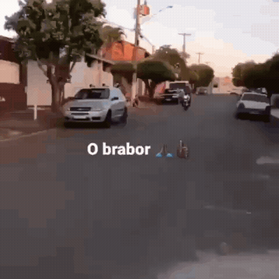 Man Riding Motorcycle Down Street GIF