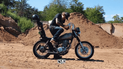 Man Riding Motorcycle In Dirt Field With Word Csnd GIF