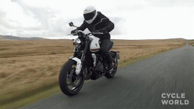 Man Riding Motorcycle On Road With Cycle World GIF