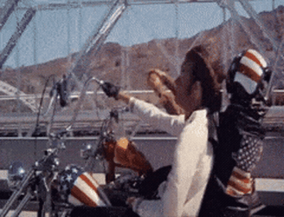 Man Riding Motorcycle With American Flag GIF