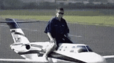 Man Riding On Back Of Small Airplane GIF