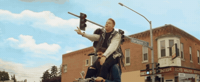 Man Riding On Shoulders In Front Of Scott Walker Sign GIF