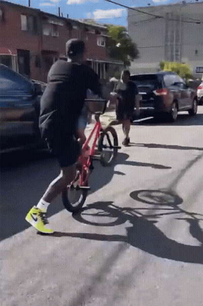 Man Riding Red Bike With JC License Plate GIF