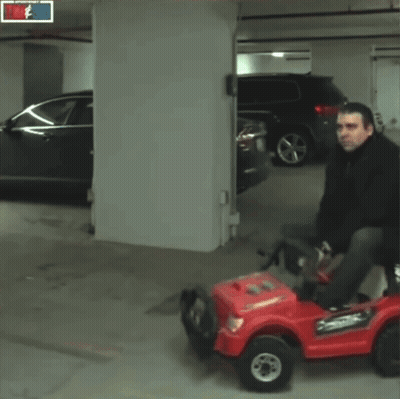 Man Riding Red Car With Tim Sid Sign GIF