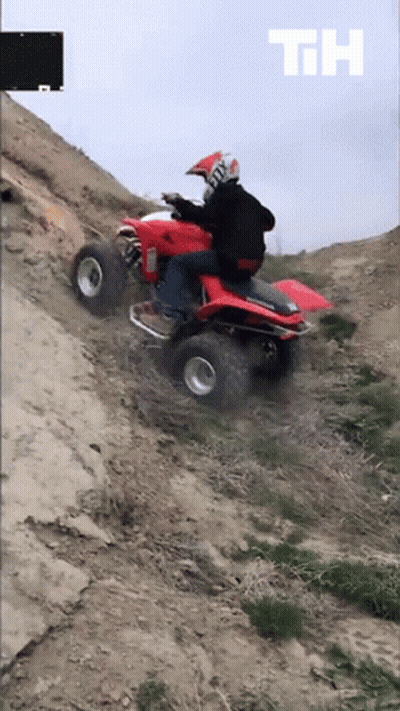 Man Riding Red Honda ATV On Dirt Road GIF