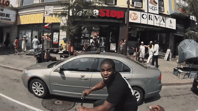 Man Riding Scooter In Front Of Free Stop Store GIF