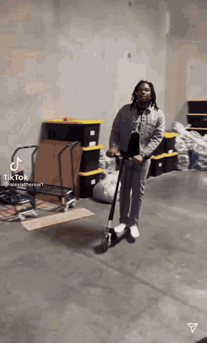 Man Riding Scooter In Warehouse GIF