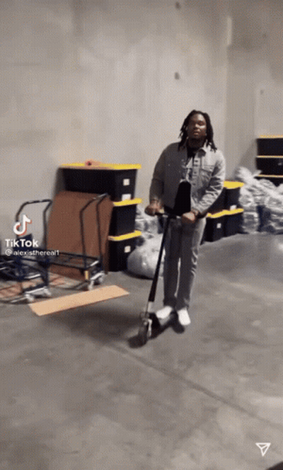 Man Riding Scooter In Warehouse GIF