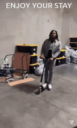 Man Riding Scooter in Warehouse