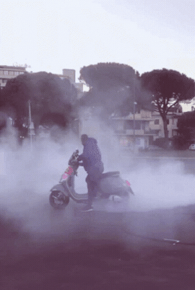 Man Riding Scooter With Smoke GIF