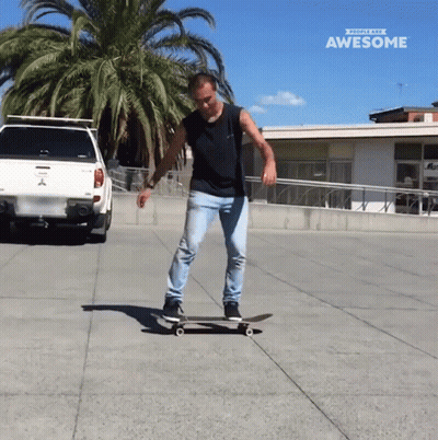 Man Riding Skateboard In Front Of Truck Saying Awesome GIF