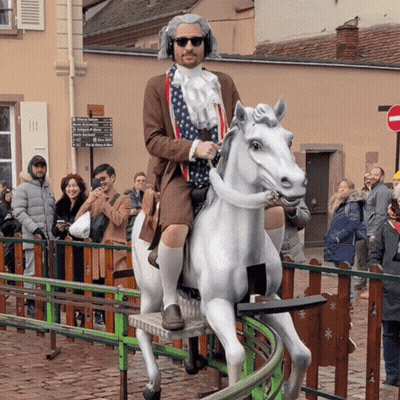 Man Riding White Horse With College Of Agriculture Sign GIF