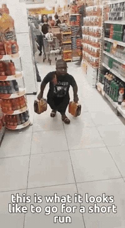Man Running Down Grocery Store Aisle With Briefcase And Bag GIF