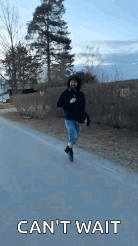 Man Running Down Road With Cant Wait Behind Him GIF