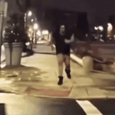 Man Running Down Sidewalk at Night