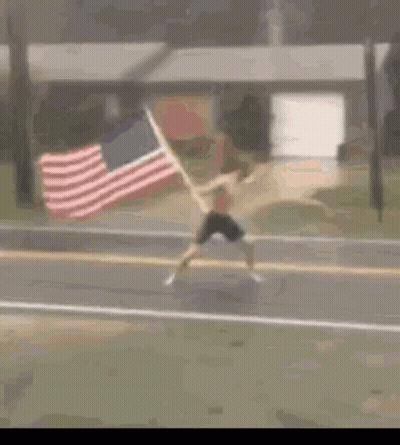 Man Running Down Street With American Flag GIF