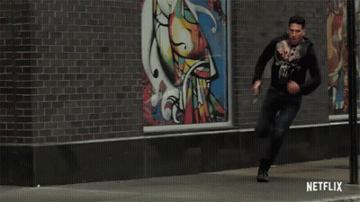 Man Running Down Street With Netflix Logo GIF