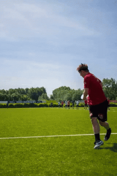 Man Running On Field In Red Shirt And Black Shorts GIF