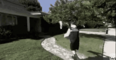 Man Running On Sidewalk Past House GIF