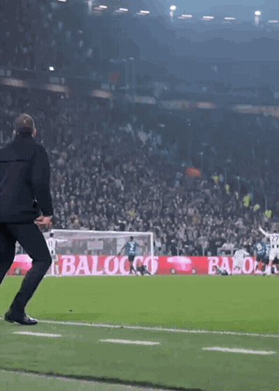 Man Running On Soccer Field Past Baloco Sign GIF