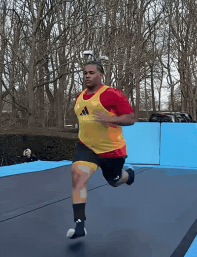 Man Running On Trampoline In Red And Yellow Adidas Vest GIF