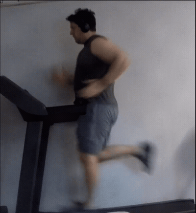 Man Running On Treadmill With Headphones GIF