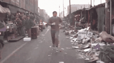 Man Running Past Pile Of Cardboard Boxes GIF