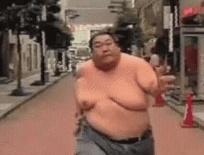 Man Running Shirtless Downtown GIF