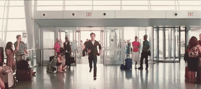 Man Running Through Airport With Exit Sign GIF