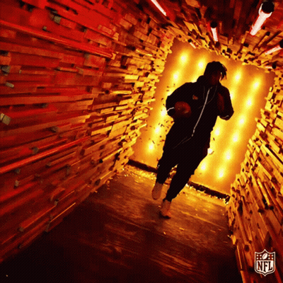 Man Running Through Wooden Tunnel With NFL Logo GIF