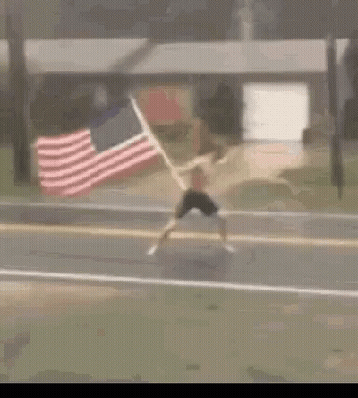 Man Running With American Flag Behind GIF