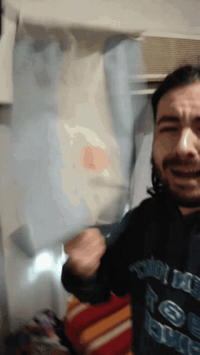 Man's Face Among Plants GIF
