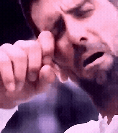 Man's Face Close Up On Pink Background GIF