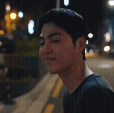 Man's Face Close Up On Sidewalk At Night GIF