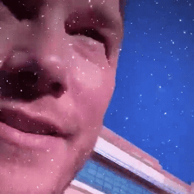 Man's Face Close Up With Falling Snow GIF