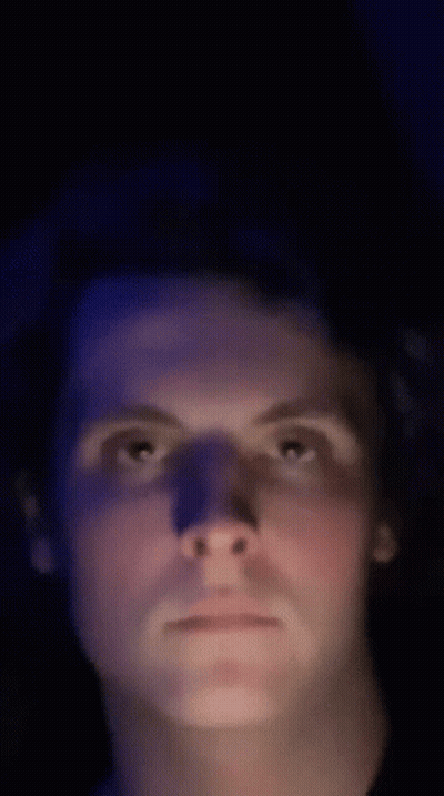 Man's Face In Dark Room With Blue Light GIF