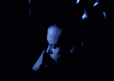 Man's Face In Dark Room With Blue Light GIF