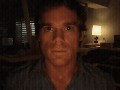 Man's Face In Dark Room With Lamp GIF