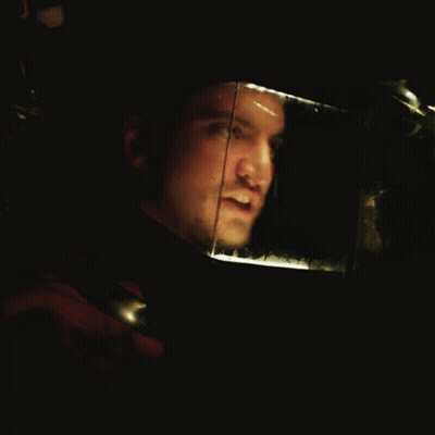 Man's Face In Dark Room With Reflection GIF