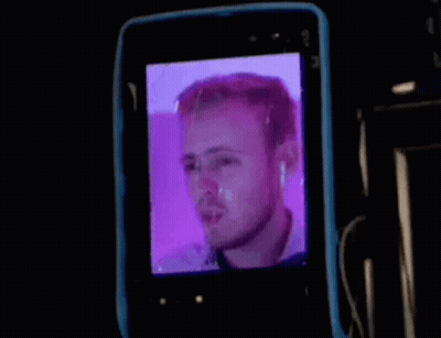 Man's Face On Cell Phone Screen GIF
