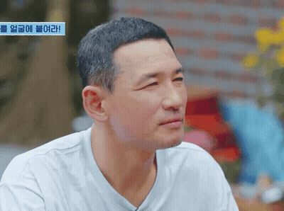 Man's Face With Blue Sign Saying Korean GIF