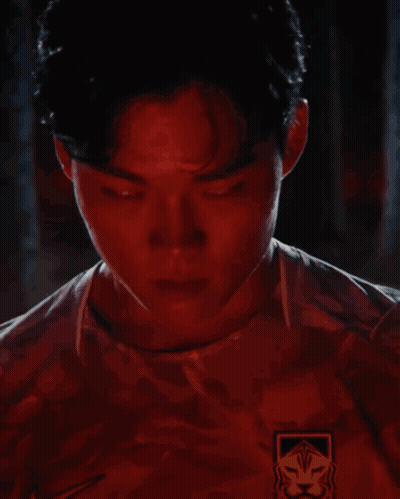 Man's Face With Red Lights Behind GIF