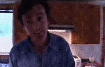 Man's Face With Reflection In Dark Room GIF