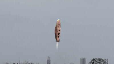 Man's Head Coming Out Of Air In Front Of City GIF