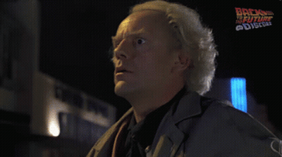 Man Saying Great Scott in Front of Back to the Future Poster