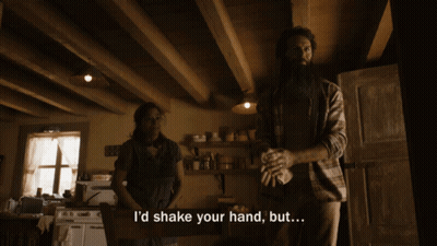 Man Saying I'd Shake Your Hand But In Kitchen With Woman GIF