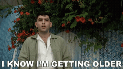 Man Saying I Know I'm Getting Older In Front Of Flowers GIF